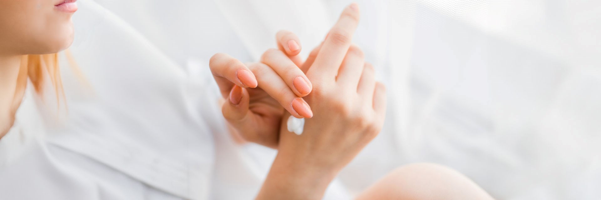 Woman moisturising her hands