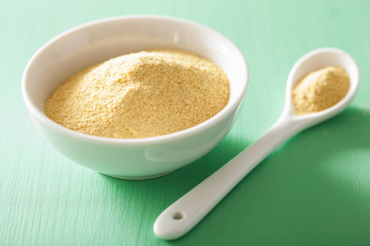 Bowl of nutritional yeast with spoon