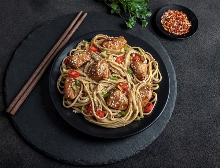 Sesame chicken noodles with greens in ginger-soy dressing