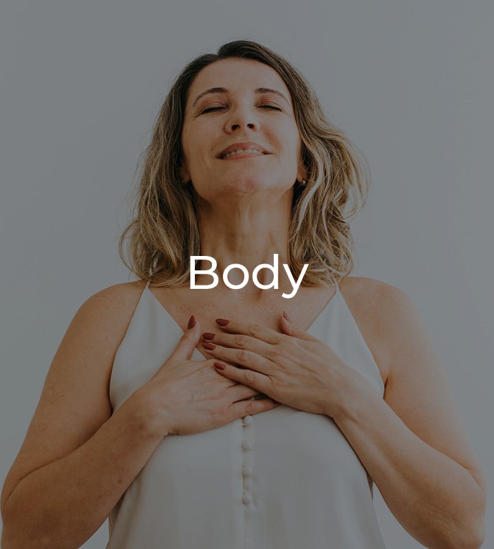 Woman with hands clasped on chest looking happy