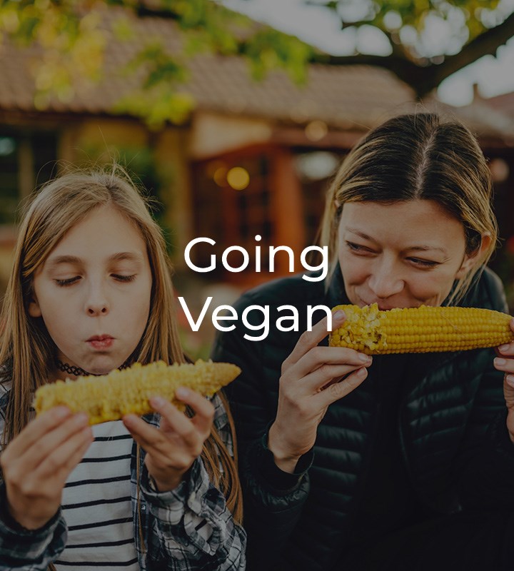 Mother and daughter eating corn on the cob