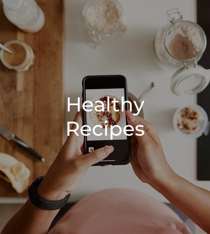 Person looking at recipes on their phone over table of ingredients