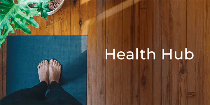 Smiling woman in cardigan looking at her phone