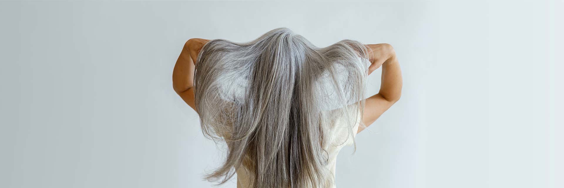 Rear view of woman with long grey hair