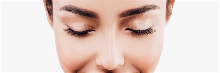 A woman smiling with her eyes shut