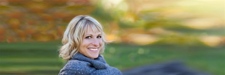 A blonde-haired woman smiling