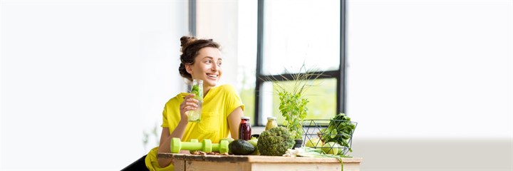 Woman smiling and drinking juice