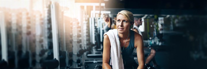 A woman sitting down in the gym