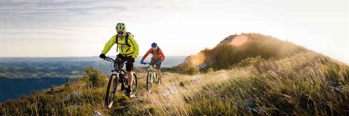 Two people cycling on a mountain