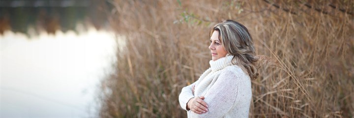 A woman looking out at a lake