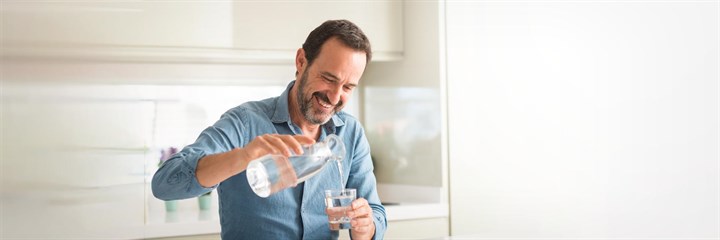 Man pouring glass of water