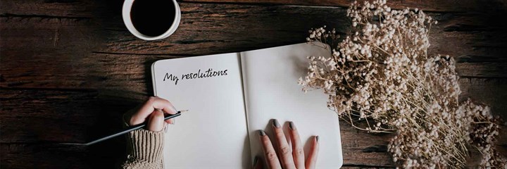 A person looking at a containing New Year's Resoultions