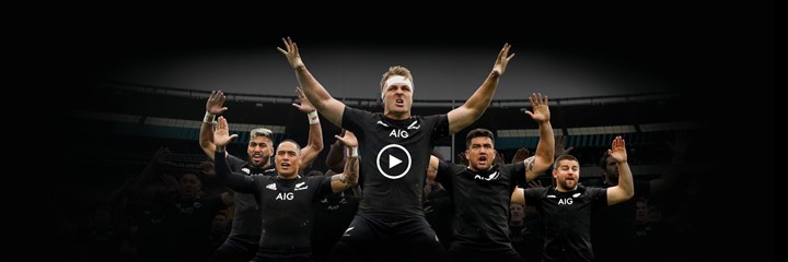 All Blacks doing the Haka on a dark background with a video play button superimposed