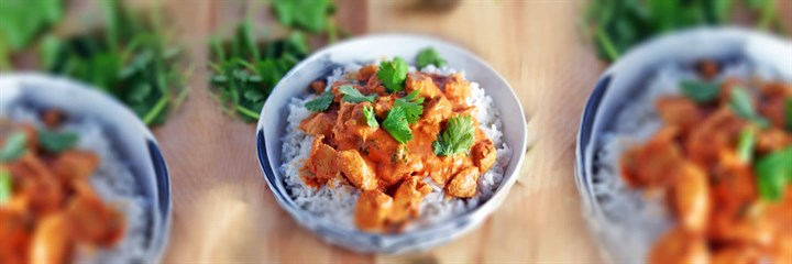 Butter chicken on rice in bowls