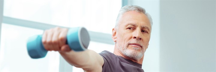 Older man lifting weights one-handed