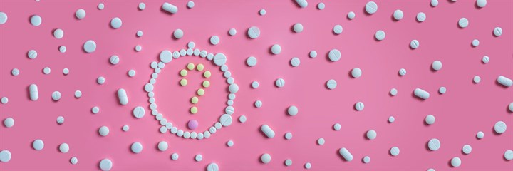 Question mark made up of tablets on pink background surrounded by other tablets