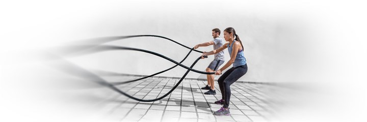 Man and woman doing battle rope exercise