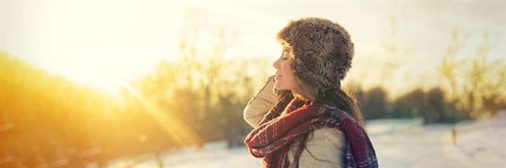 Woman in furry hat in the sunshine
