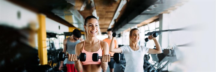 Smiling women working out in the gym