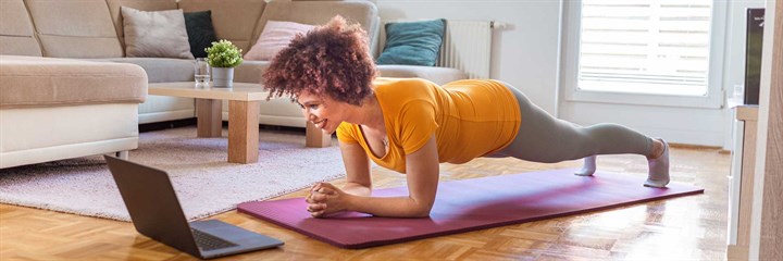 Woman in a plank position on exercise mat