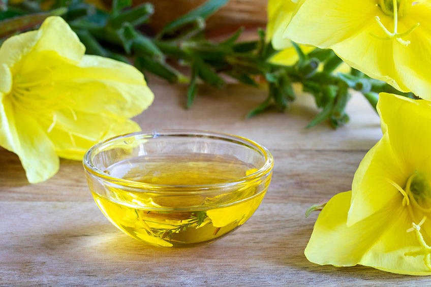 Evening primrose oil in dish with flowers