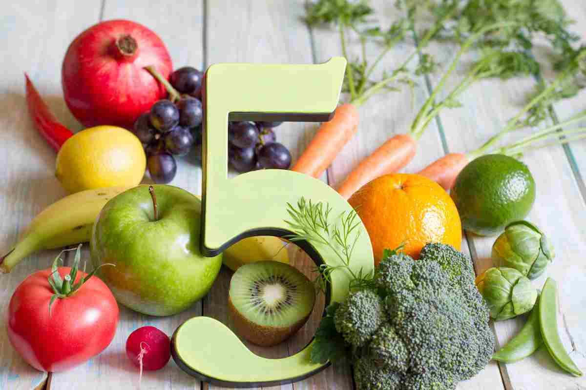 The number five surrounded by fruit and vegetables