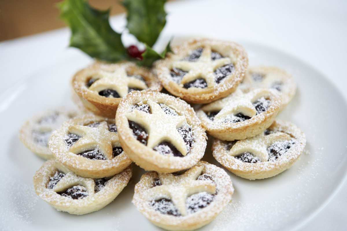 Star mince pies on plate with holly sprig