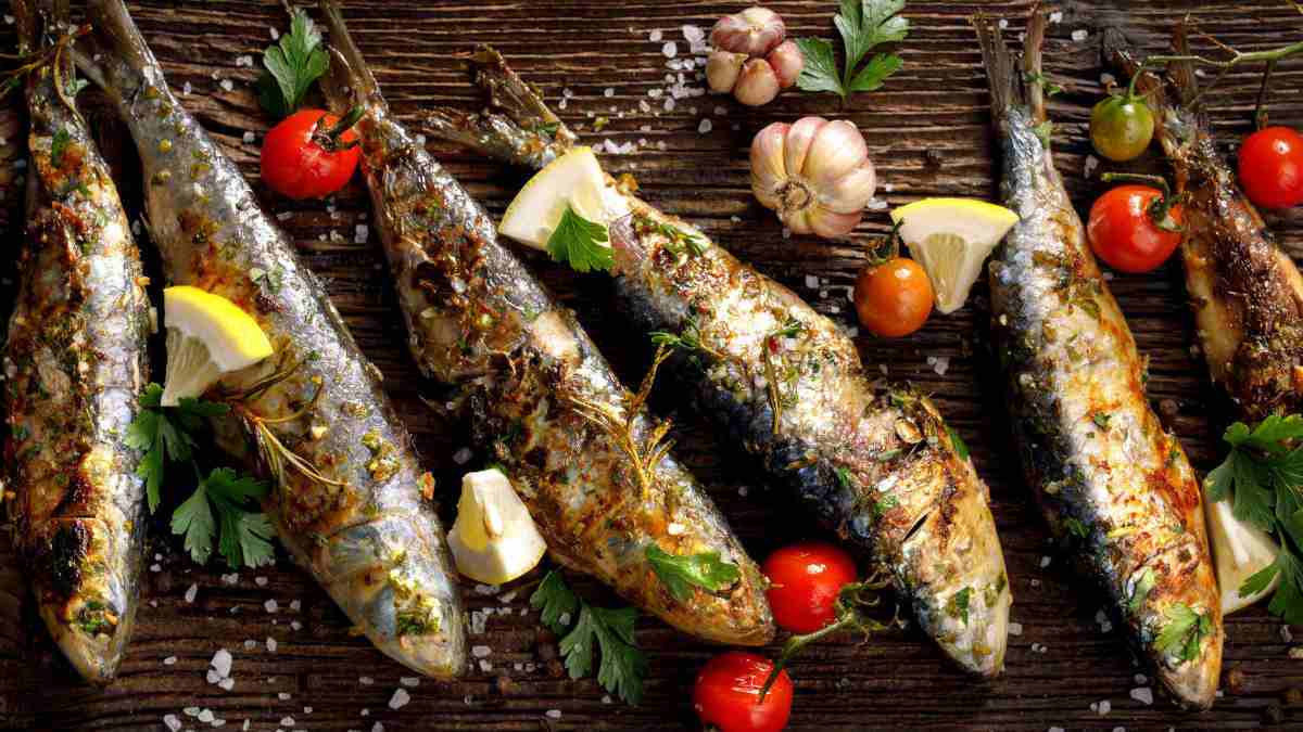 Sardines and tomatoes on a wooden board