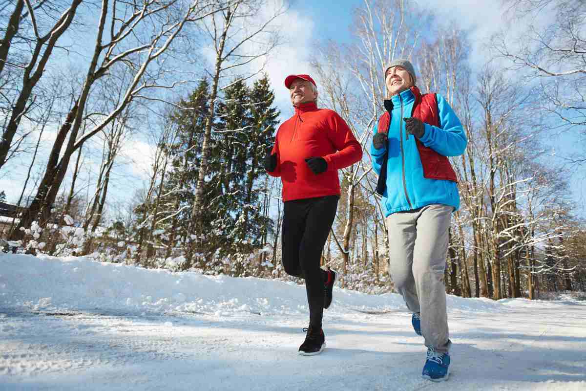Older couple running in the snow