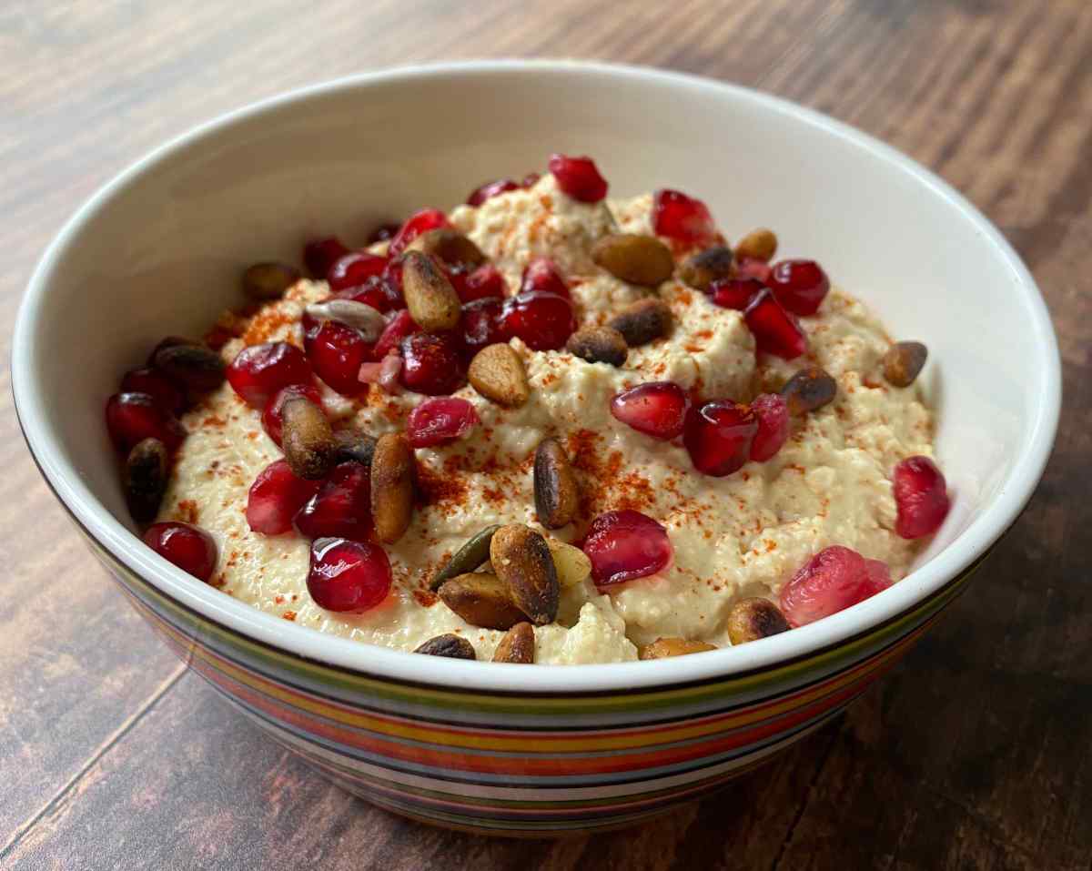 Festive hummus topped with dried cranberries and pine nuts