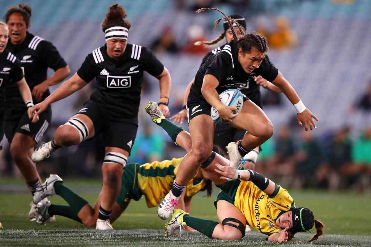 Black Ferns running and jumping over competitors