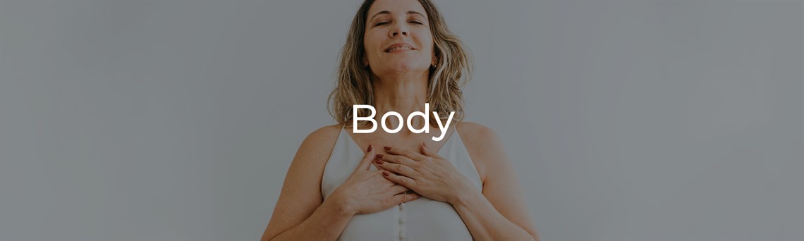 Woman with hands clasped on chest looking happy