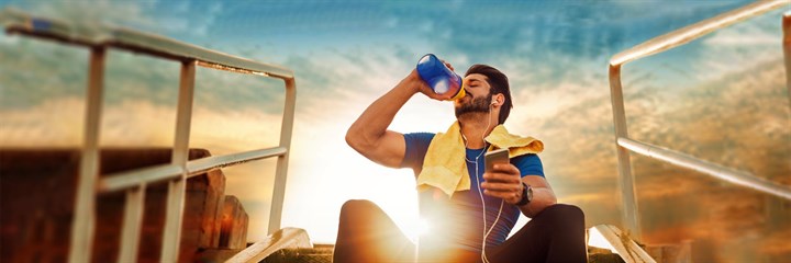 Image of a man drinking after doing exercise