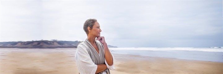 A middle-aged woman looking out to sea