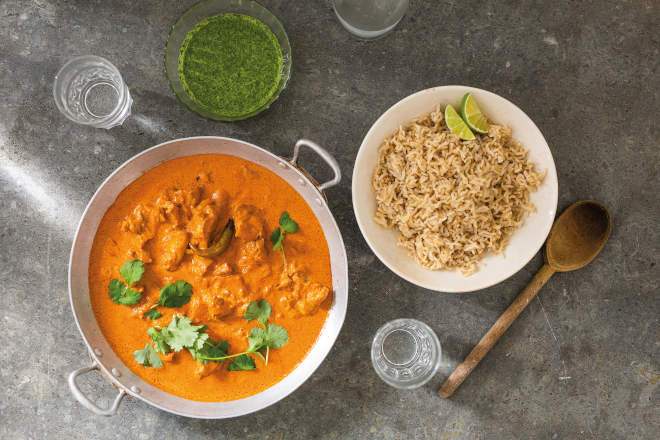 Butter chicken and rice in bowls