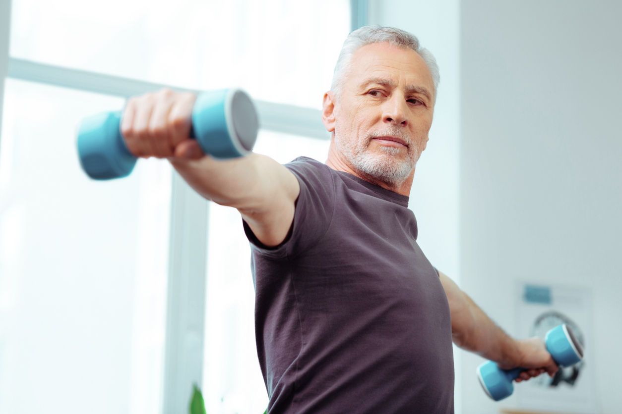 Middle-aged man lifting weights